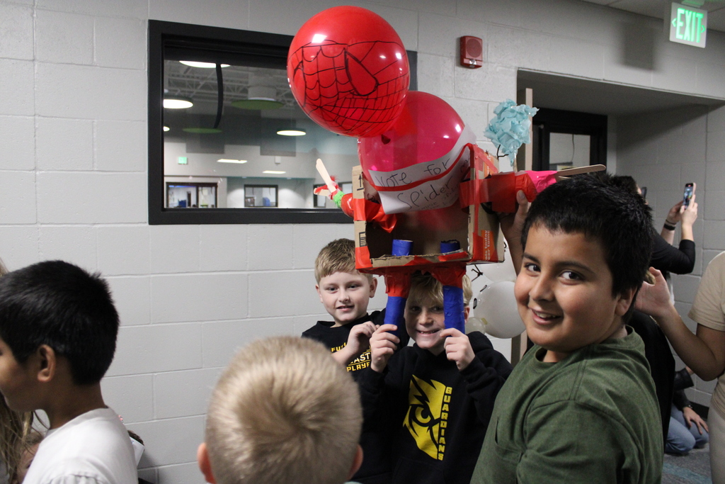 The Spider Man Balloon is carried by a group of 3rd and 5th grade students. 