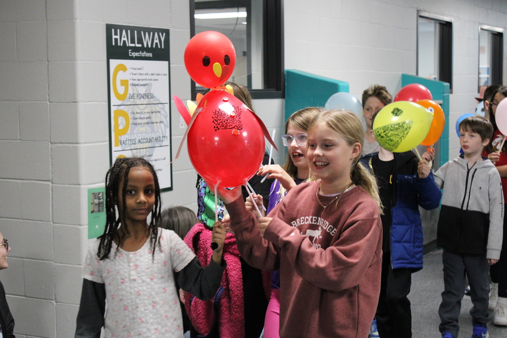 Students carry their turkey balloon together in the parade.