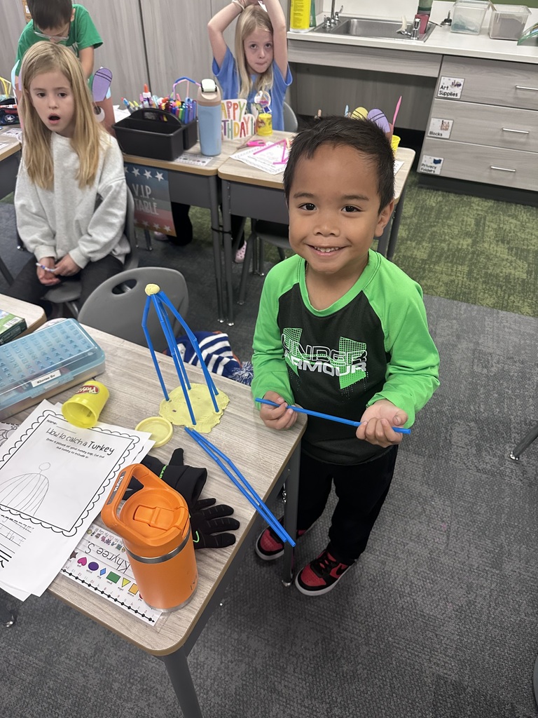 student working on a trap in their classroom to catch a turkey
