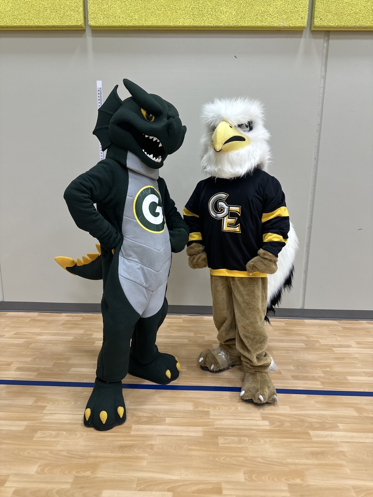 Photo of the Gretna High dragon mascot standing next to the Gretna East griffin mascot.
