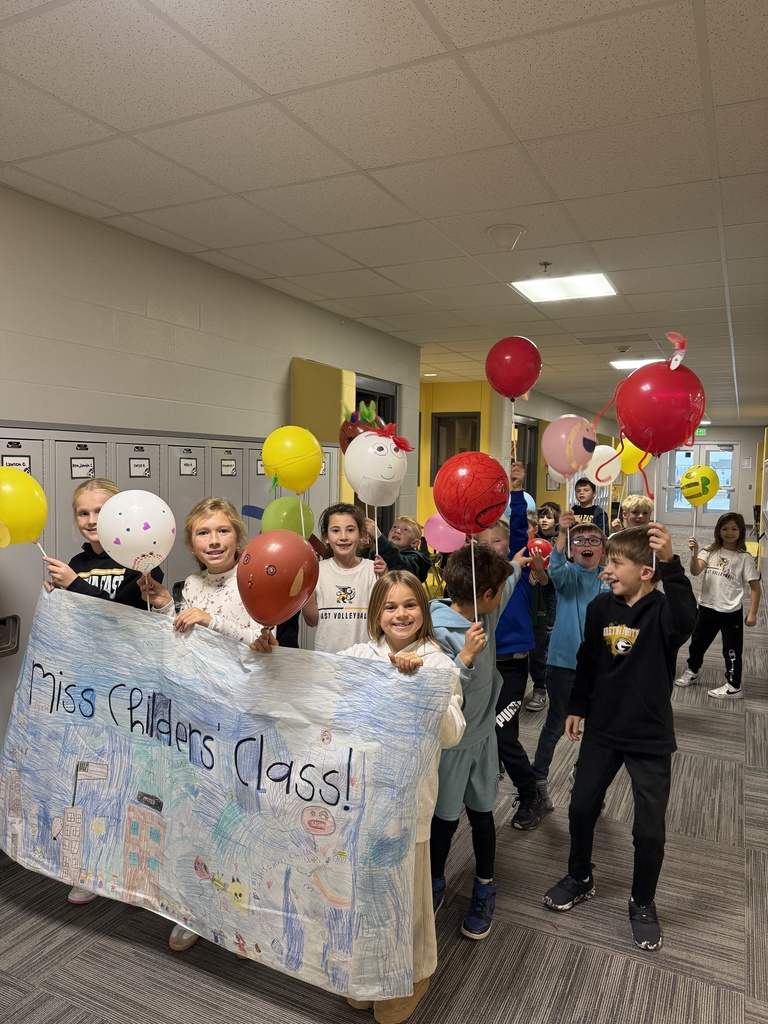 Children walking in a balloon parade