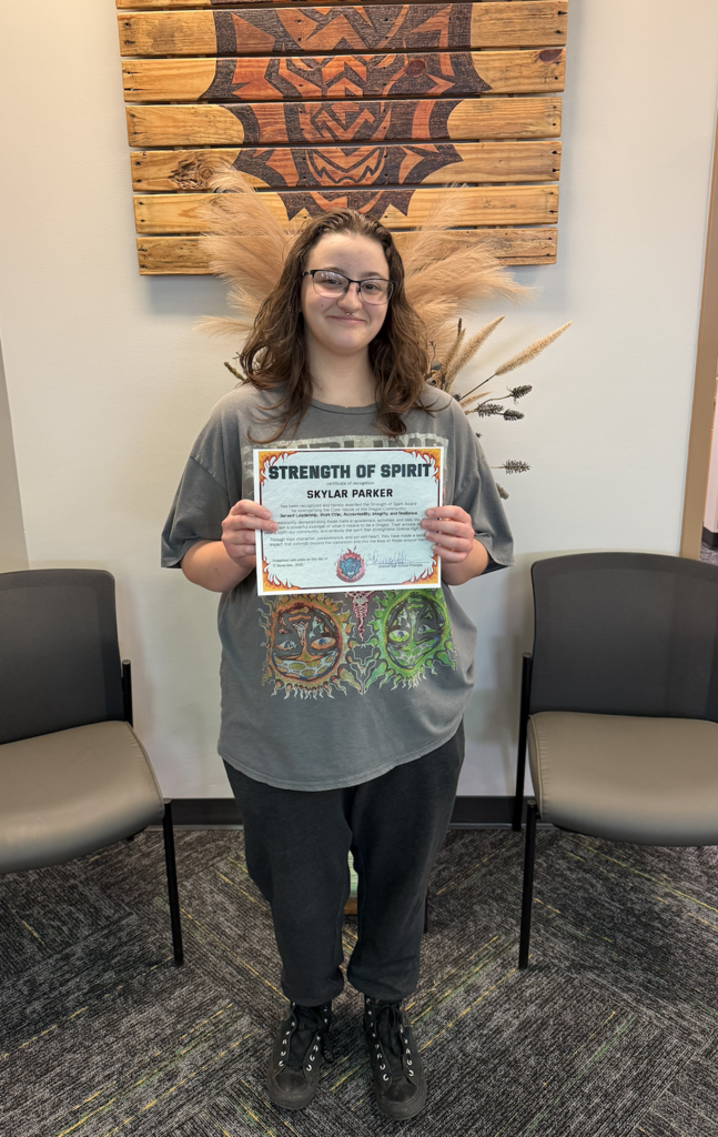 Skylar Parker holds her Strength of Spirit certificate.