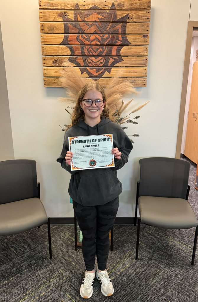 Lanie Vance holds her Strength of Spirit certificate.