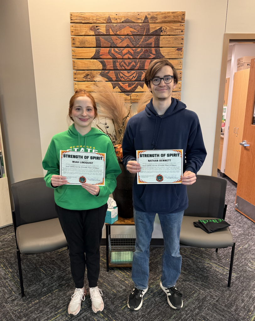 Miah Lindquit and Nathan Bennett hold their Strength of Spirit certificate.