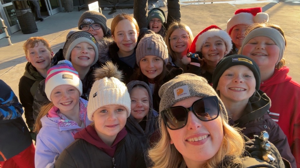 students smiling with their teacher