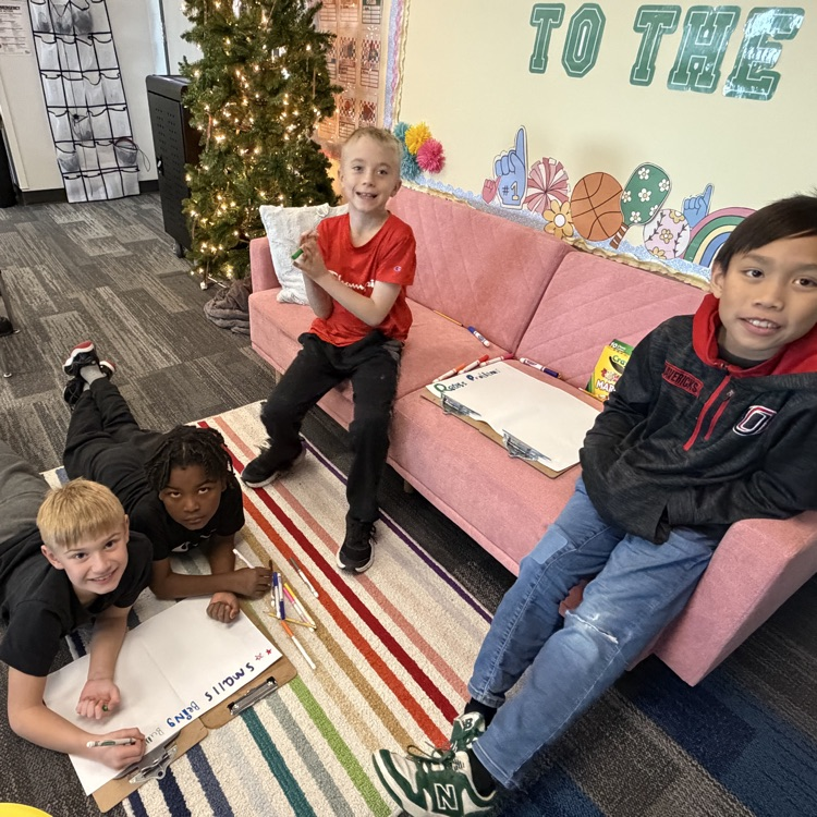 a group of four boys creating a table