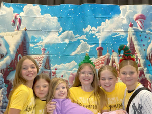 students posing in christmas festive gear in a photo booth