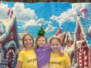 students posing in christmas festive gear in a photo booth