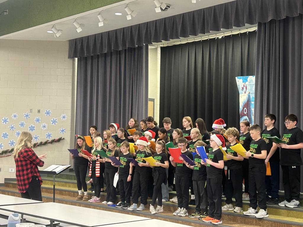 a choir of students singing on stage