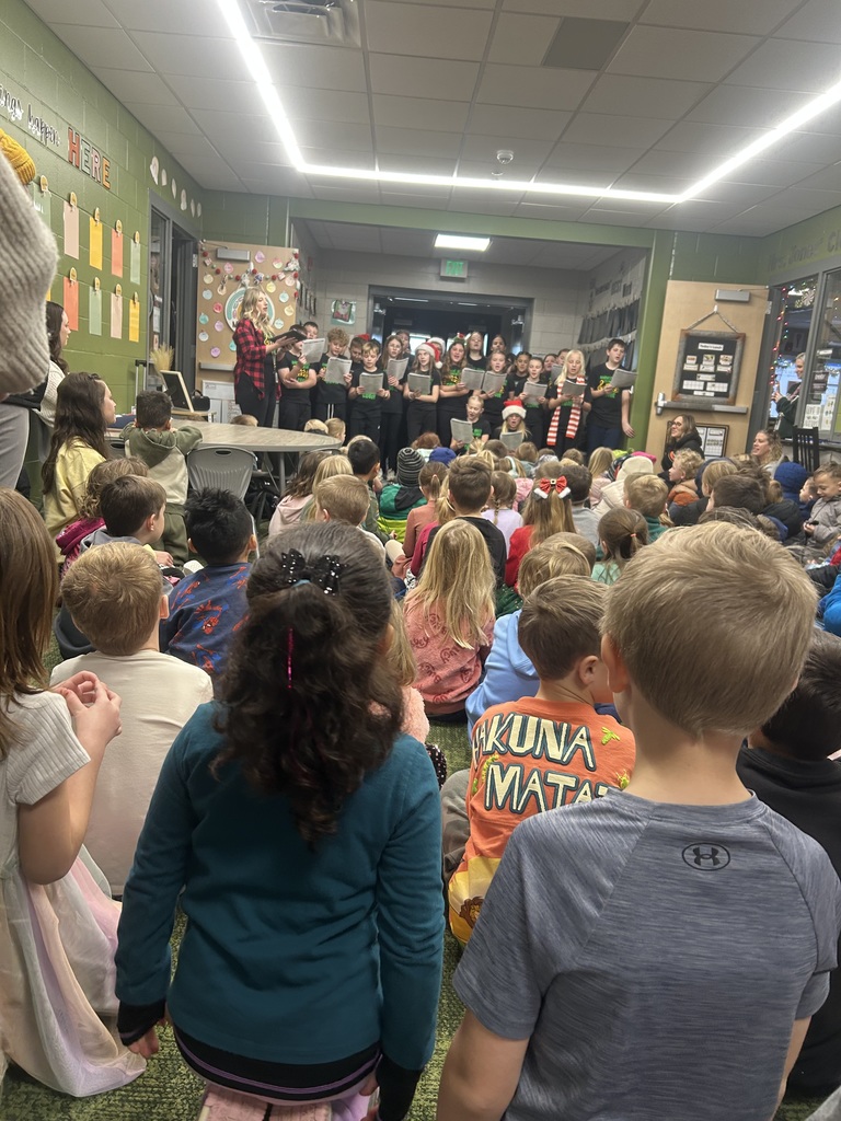 students caroling in a school