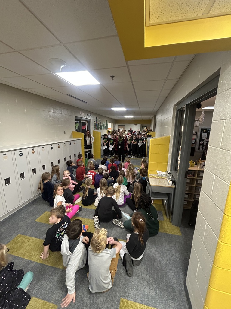 students caroling in a school
