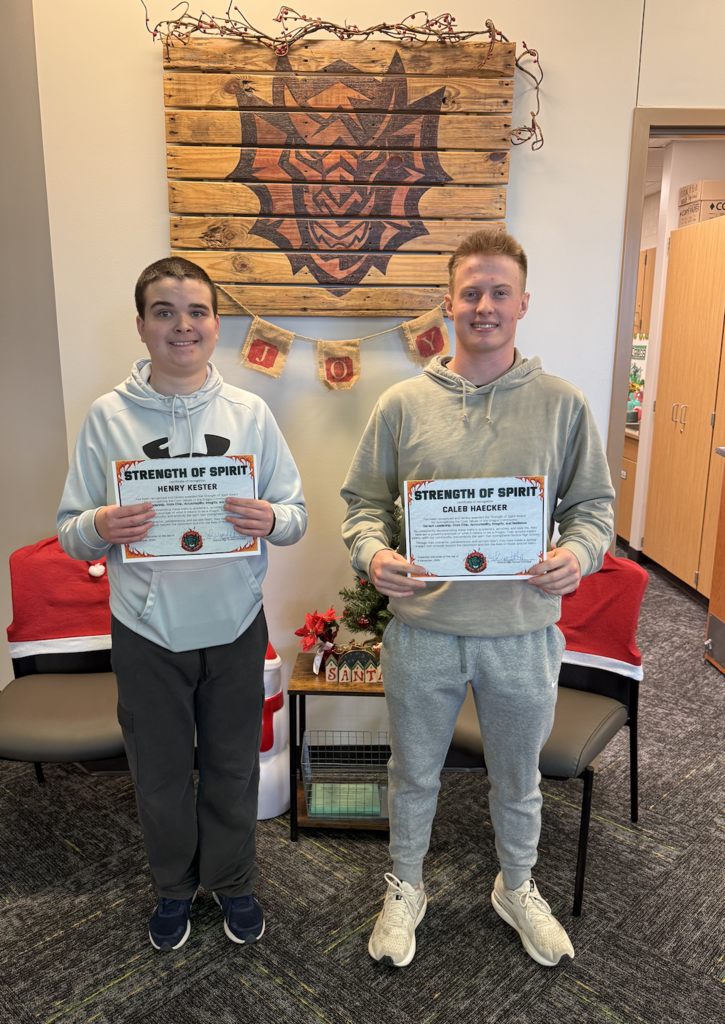 Henry Kester and Caleb Haecker hold their Strength of Spirit certificates