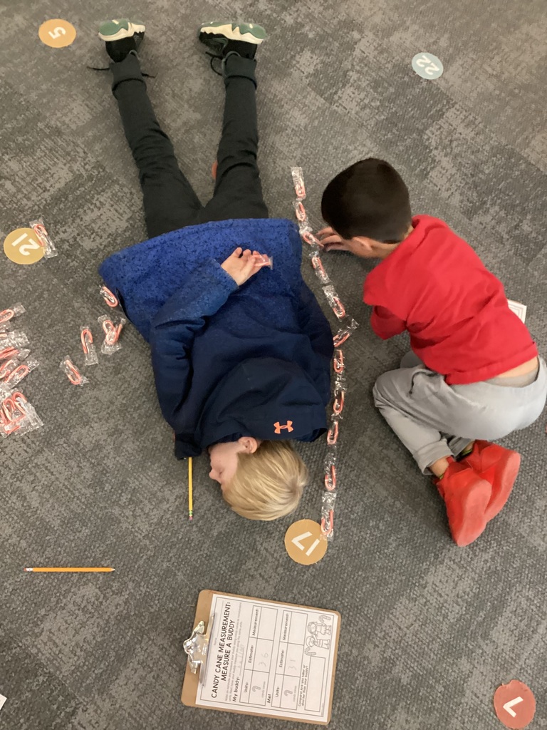 student being measured with candy canes