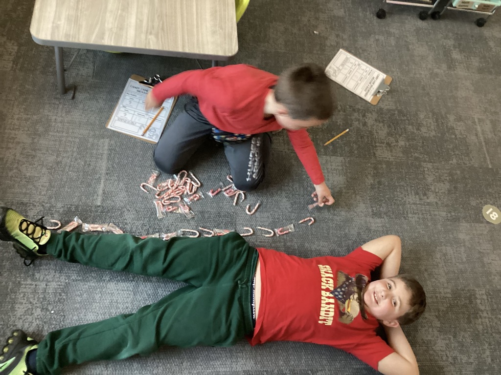 student being measured with candy canes