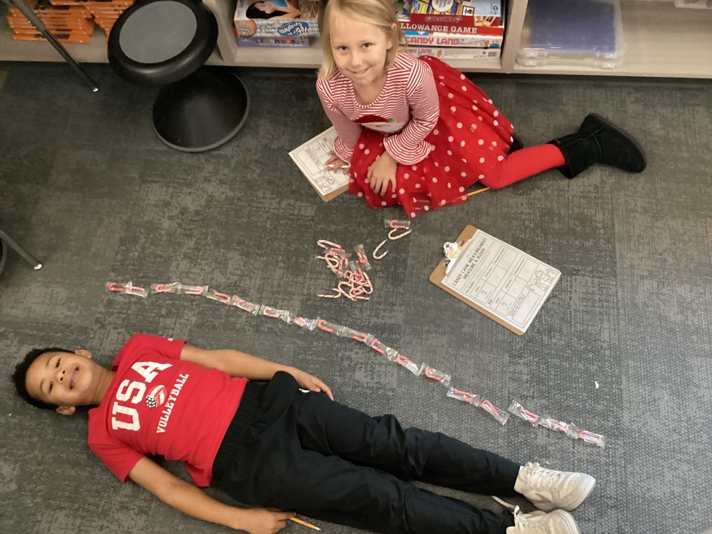 student being measured with candy canes