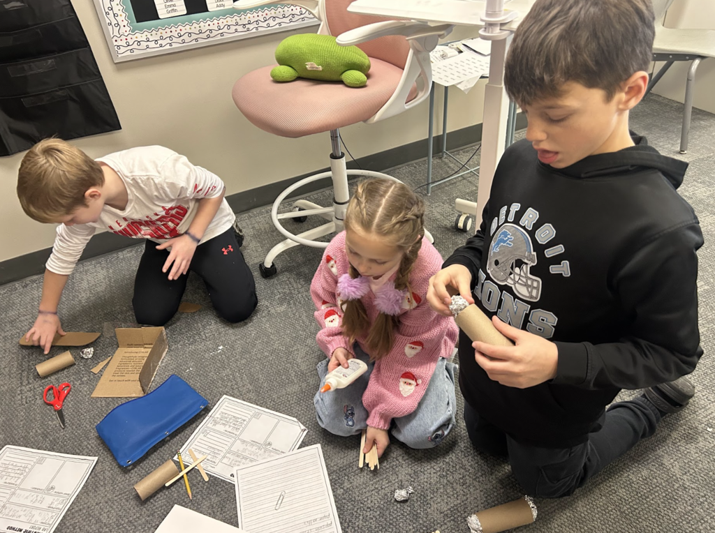 students working on a science project in class of building a boat with materials