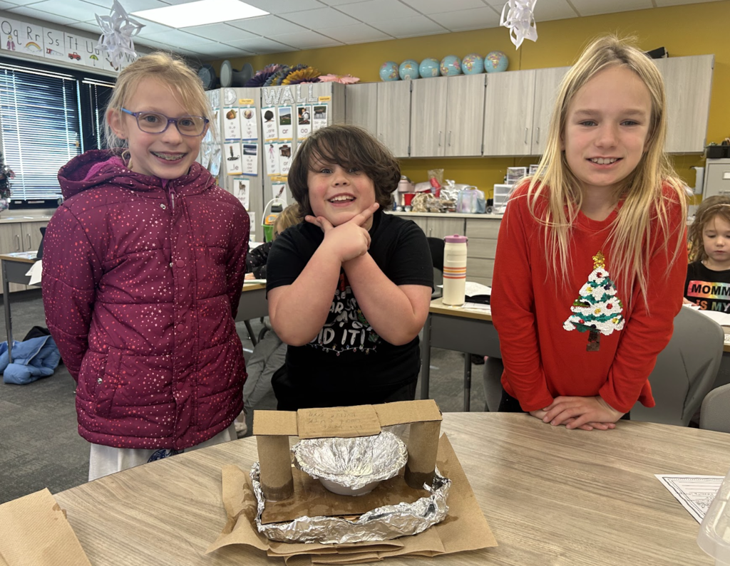 students working on a science project in class of building a boat with materials