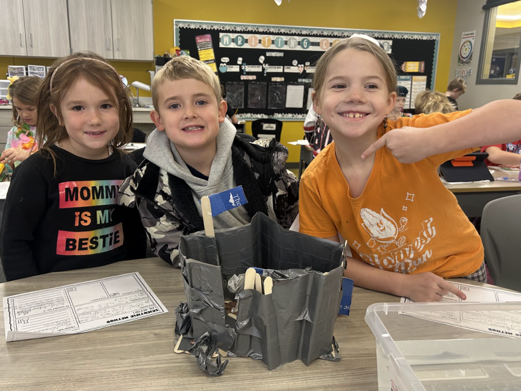 students working on a science project in class of building a boat with materials