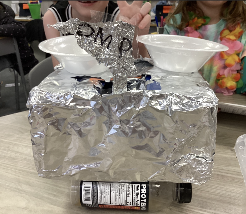 students working on a science project in class of building a boat with materials