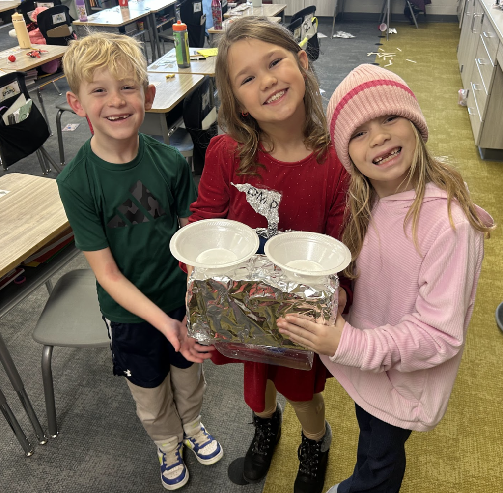 students working on a science project in class of building a boat with materials
