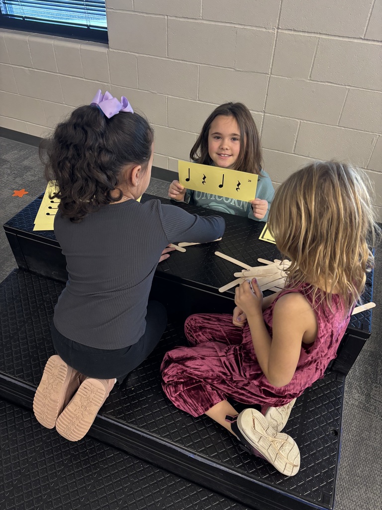 Students working on rhythm with popsicle sticks