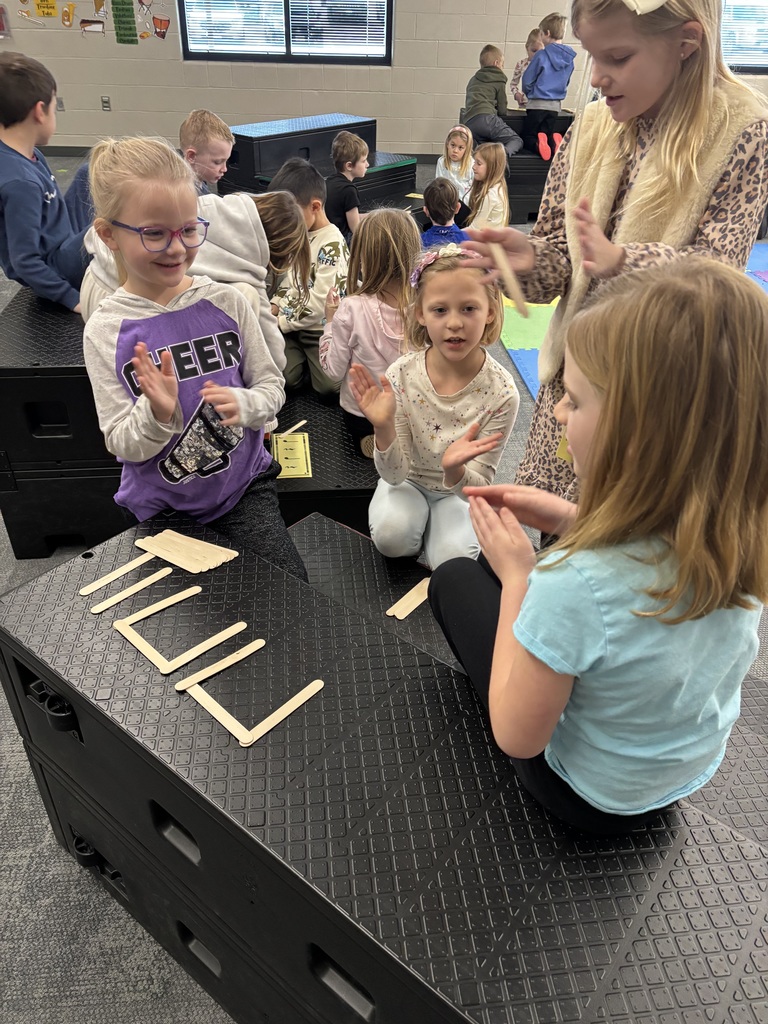 Students working on rhythm with popsicle sticks