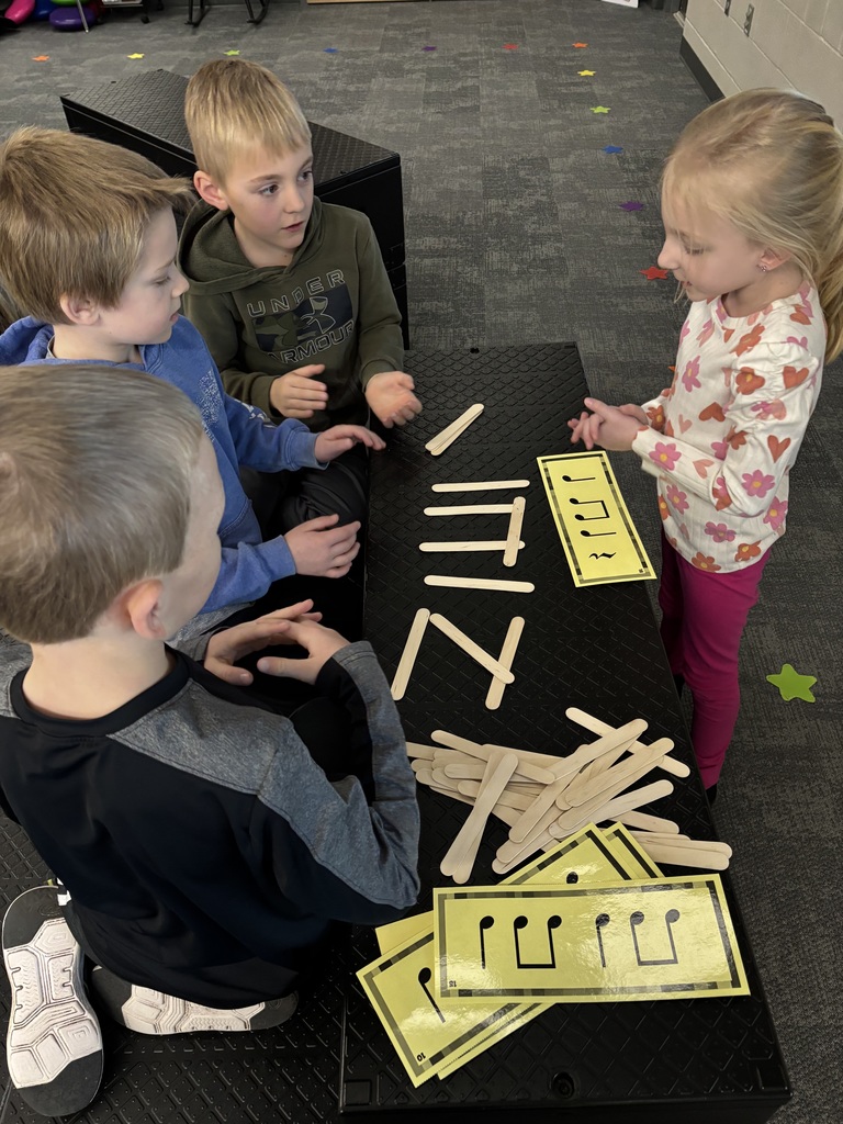 Students working on rhythm with popsicle sticks