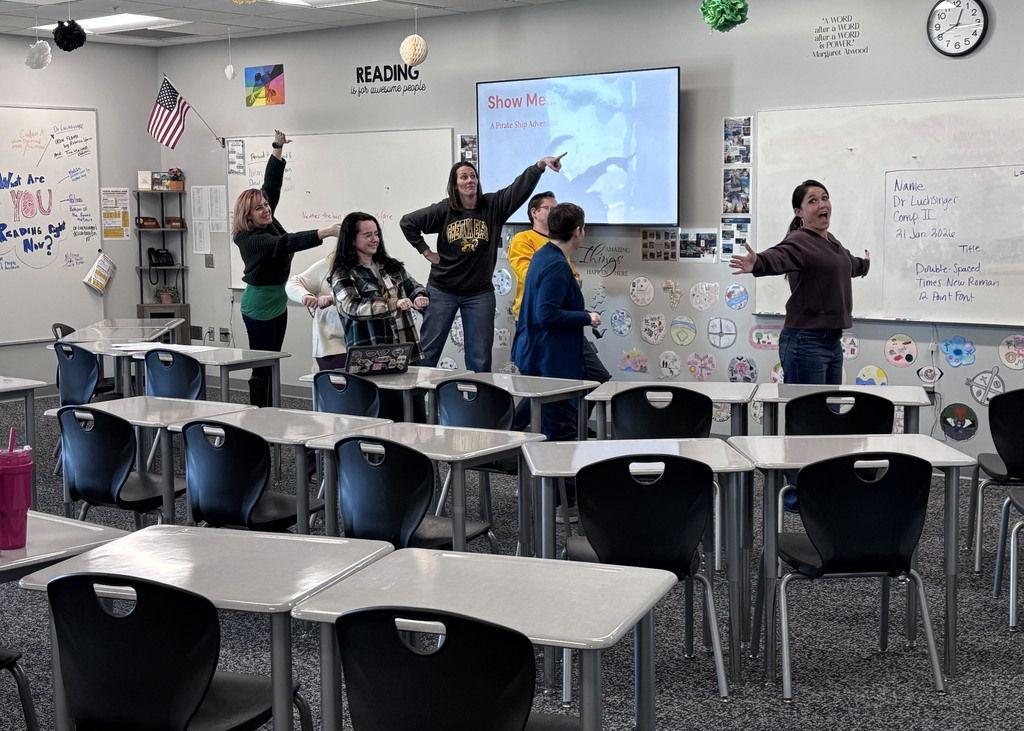 teachers in front of classroom acting out different words and phrases