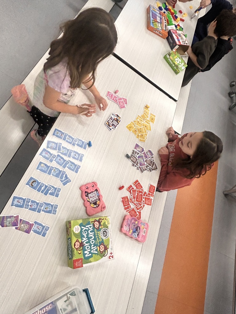 students playing game in the cafeteria to celebrate the 100th day of school