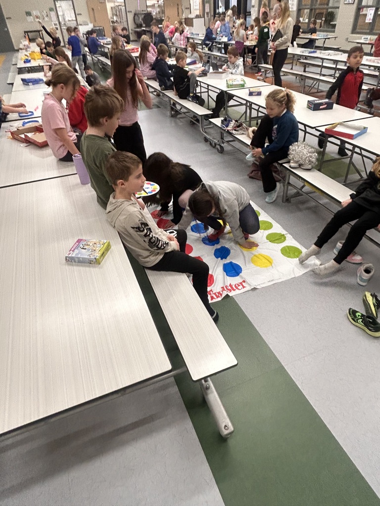 students playing game in the cafeteria to celebrate the 100th day of school
