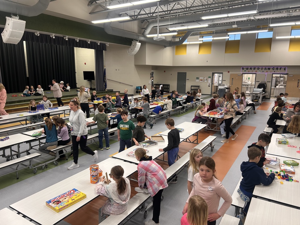students playing game in the cafeteria to celebrate the 100th day of school