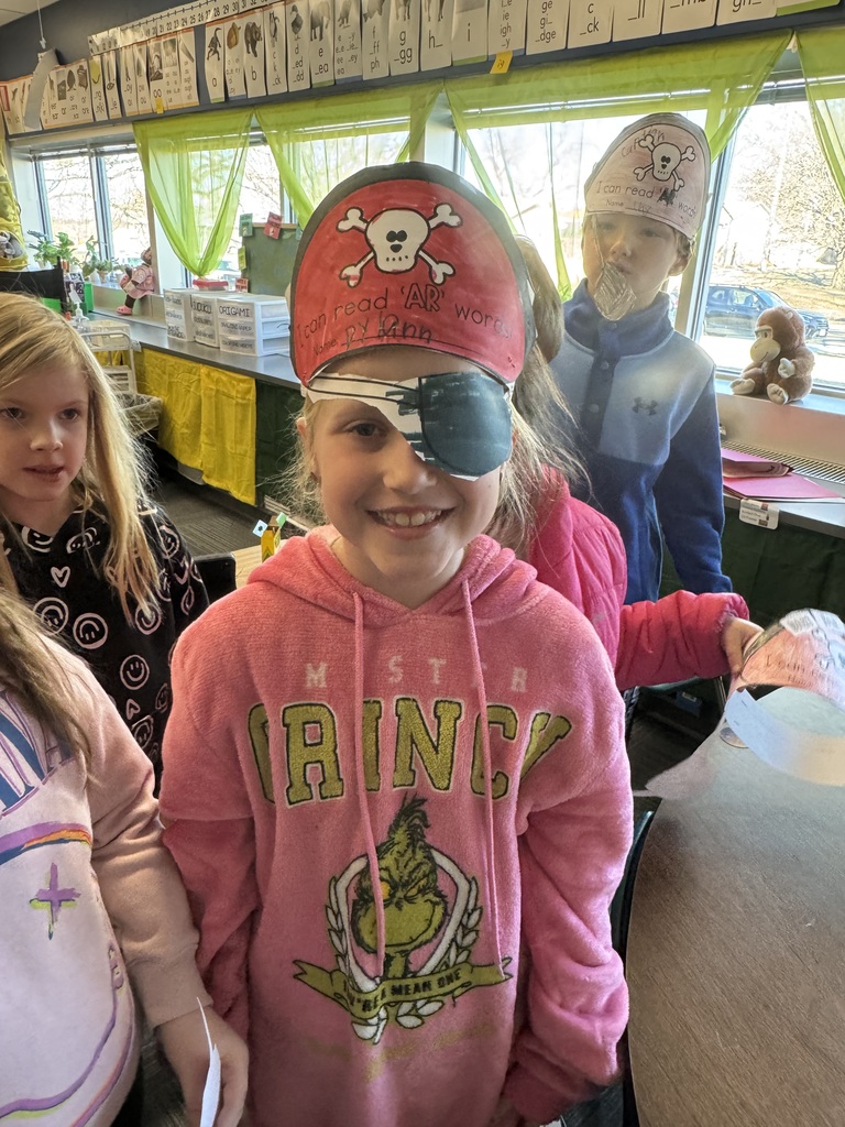 Girl wearing a pirate hat and a paper eye patch