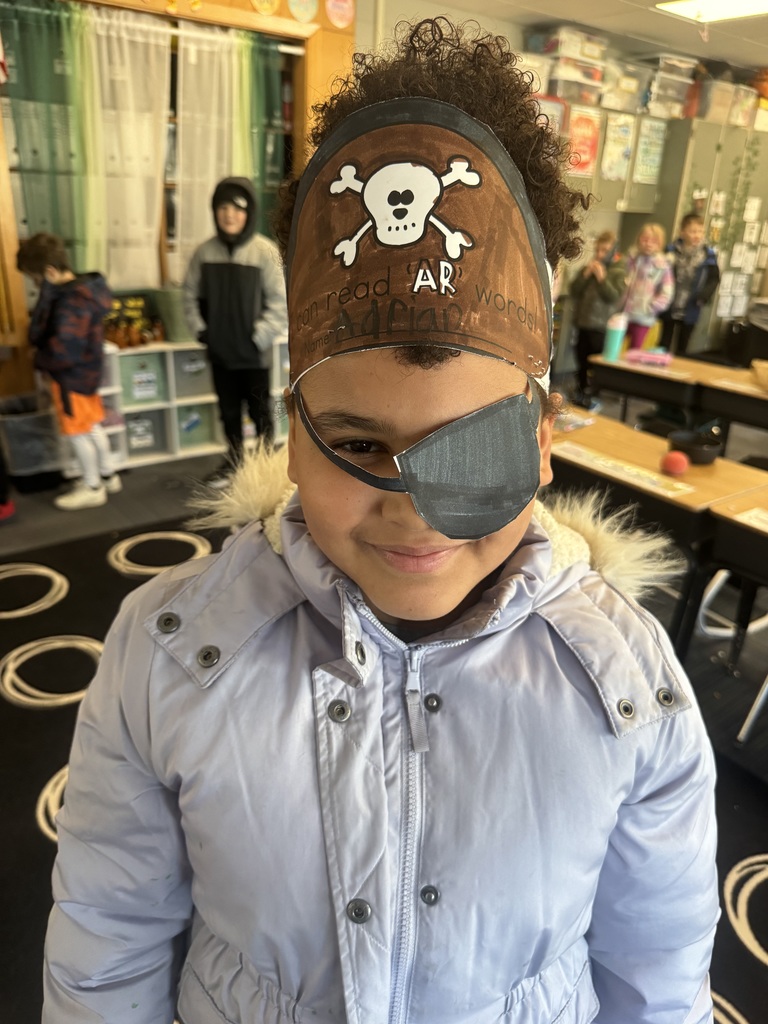 Girl wearing a pirate hat and a paper eye patch
