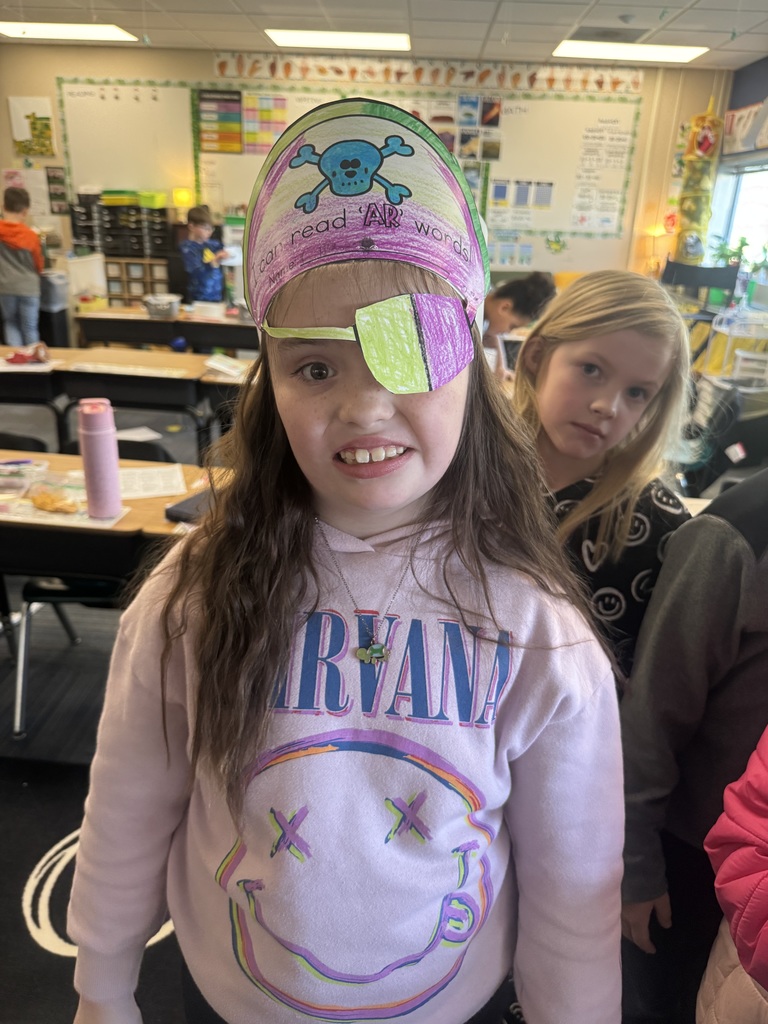 Girl wearing a pirate hat and a paper eye patch