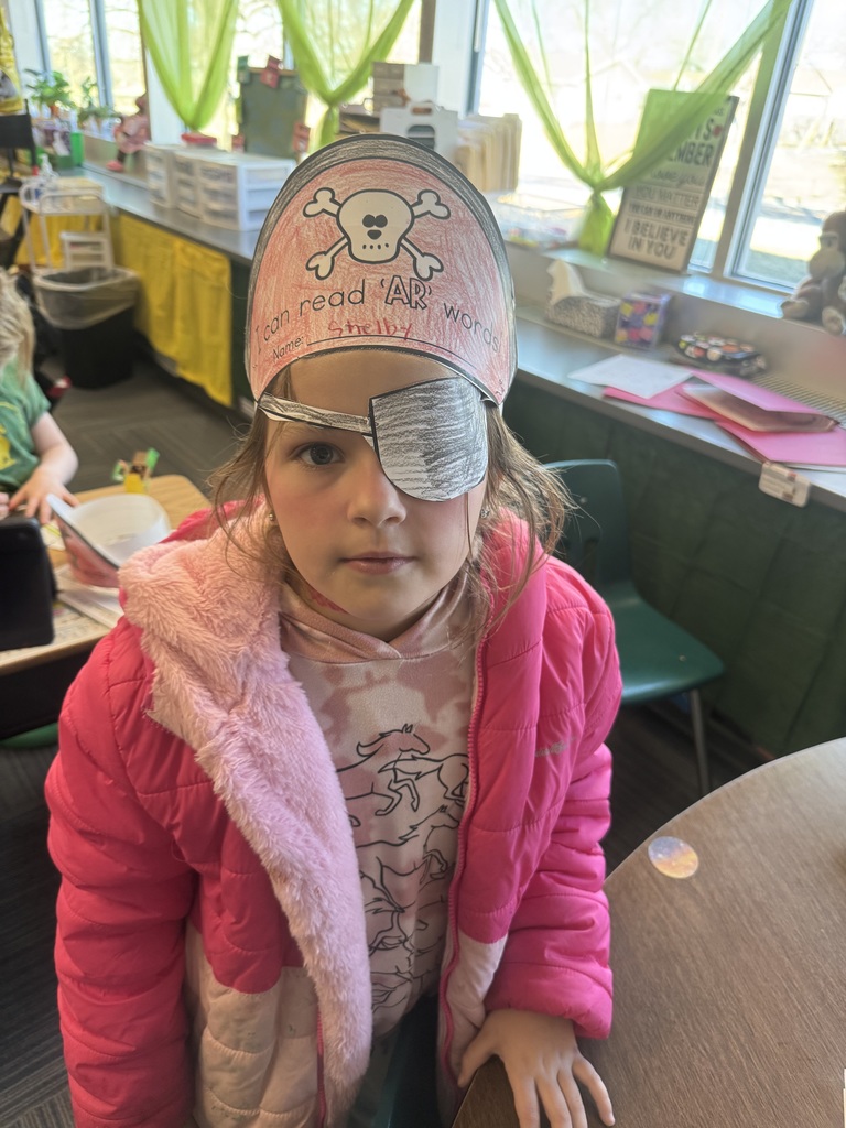 Girl wearing a pirate hat and a paper eye patch