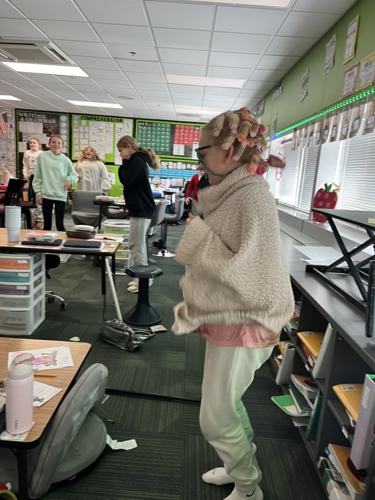 Students standing and smiling in a classroom