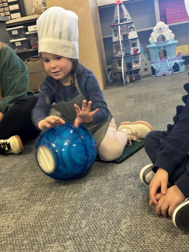 students rolling around an ice cream making ball to make ice cream from scratch