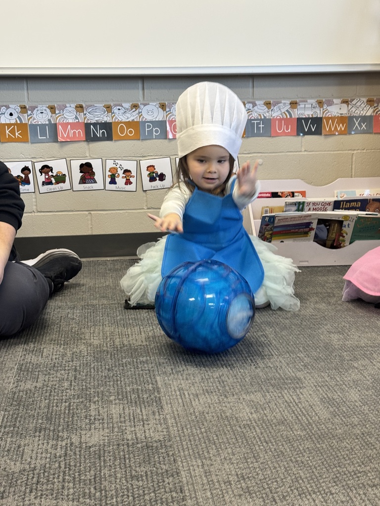 students rolling around an ice cream making ball to make ice cream from scratch