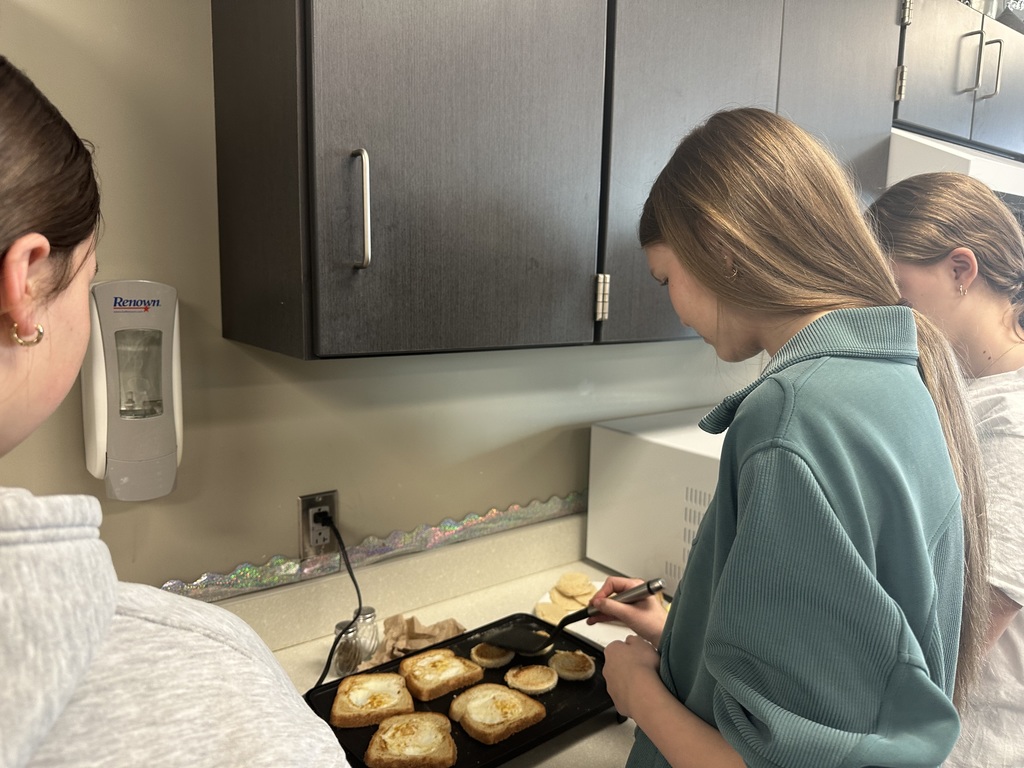 Photo of a female student making breakfast on a griddle.