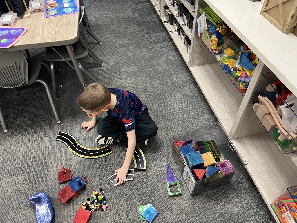 student playing with magnatiles