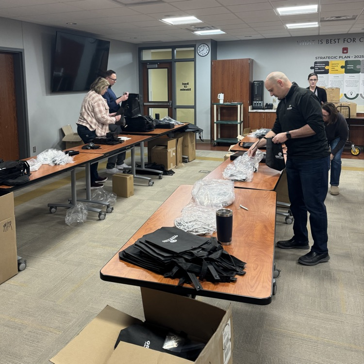 tables filled with items being packed in gift bags