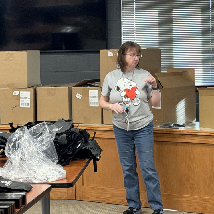district office worker standing in front of board room getting ready to pack bags