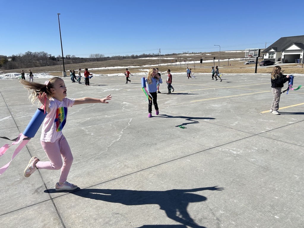 student running around with a windsock
