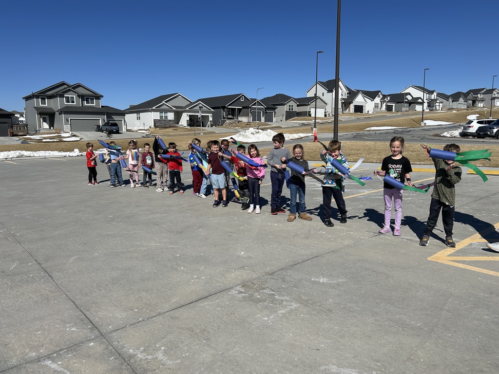Students holding windsocks outside
