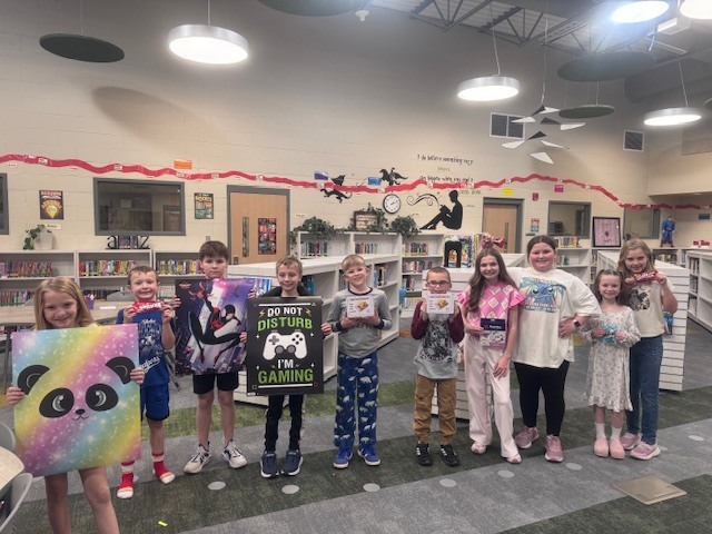 trivia winners posing in the library