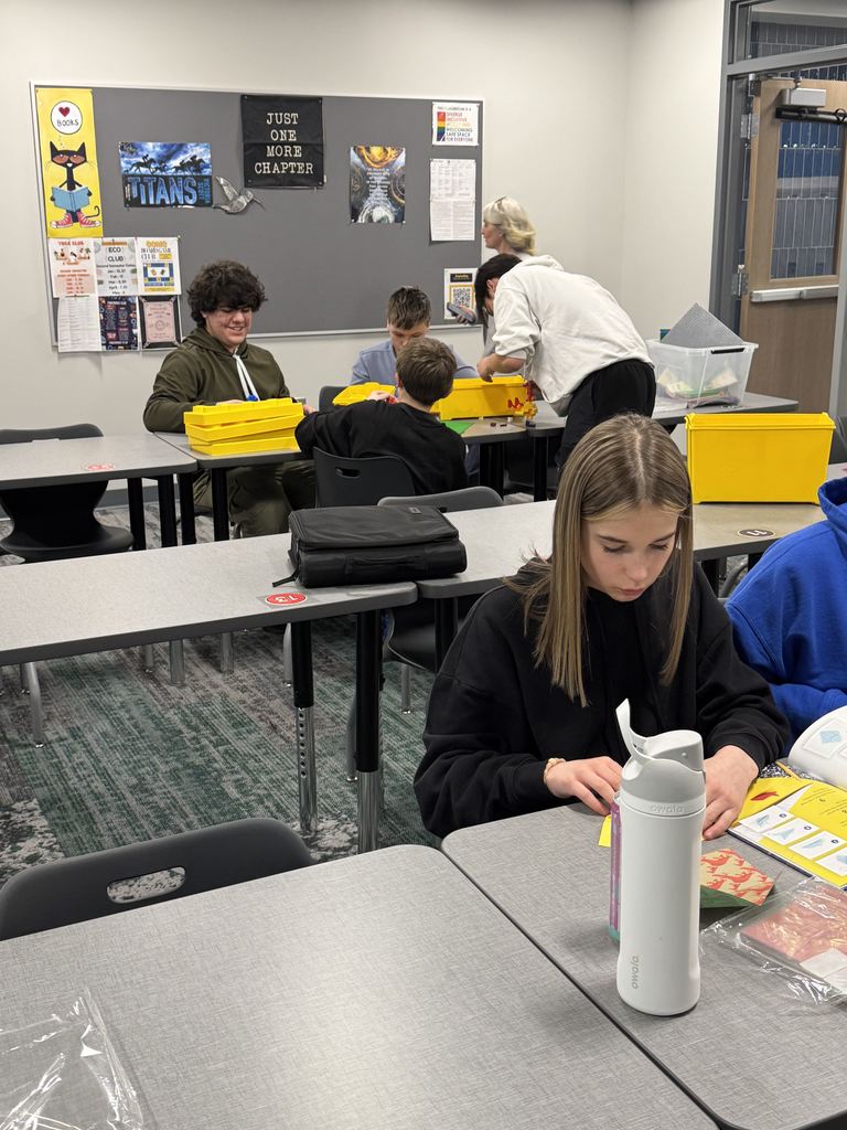 Students are working with Legos at a table. 