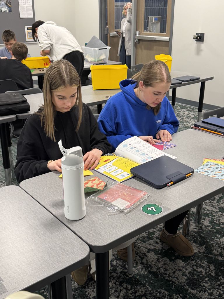 Students are folding origami. 