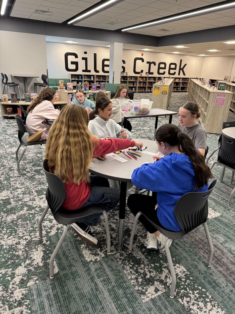 Students are sitting at desks coloring. 