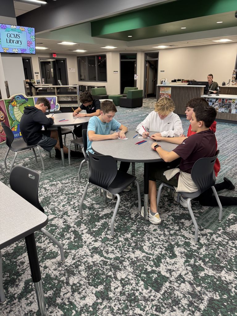 Students are sitting at desks coloring. 