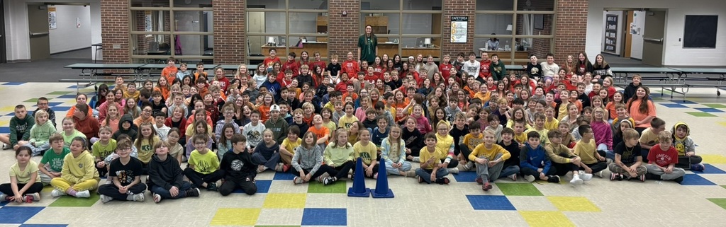 Students seated in the cafeteria with Julia Hansen